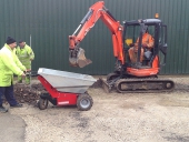 Electric Barrow being loaded by mini digger