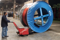 Super Power Pusher pushing steel flanged cable drum